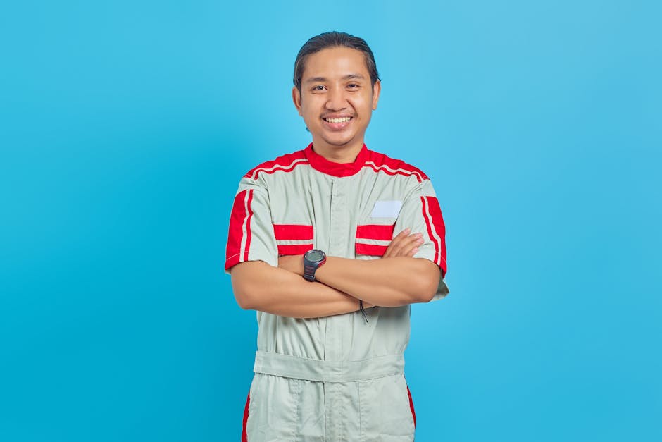 Smiling service technician standing next to a residential HVAC unit